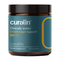 A bottle of CurLife Curcumin Supplement is shown next to a variety of herbs and spices.